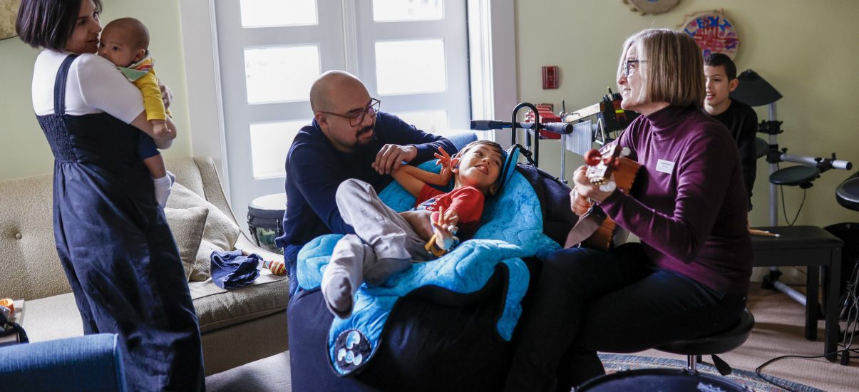 The Hernandez family with Canuck Place music therapist, Mi