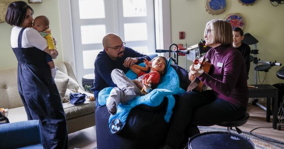 The Hernandez family with Canuck Place music therapist, Mi