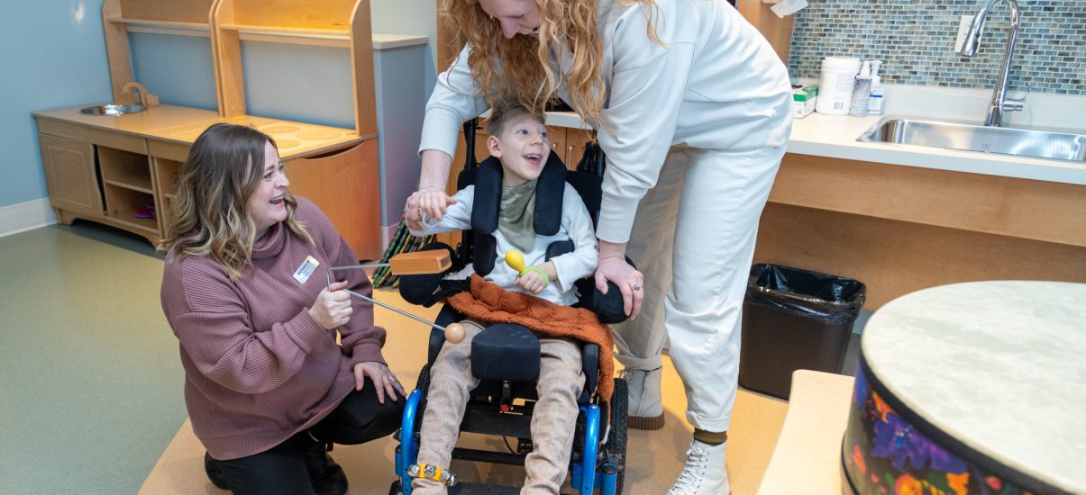 The Braun family enjoy a Music Therapy sessions with Canuck Place Music Therapist Michaela Wallis.