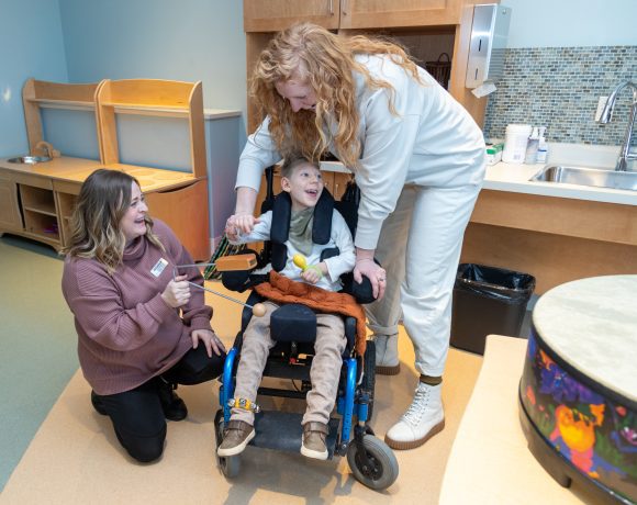 The Braun family enjoy a Music Therapy sessions with Canuck Place Music Therapist Michaela Wallis.