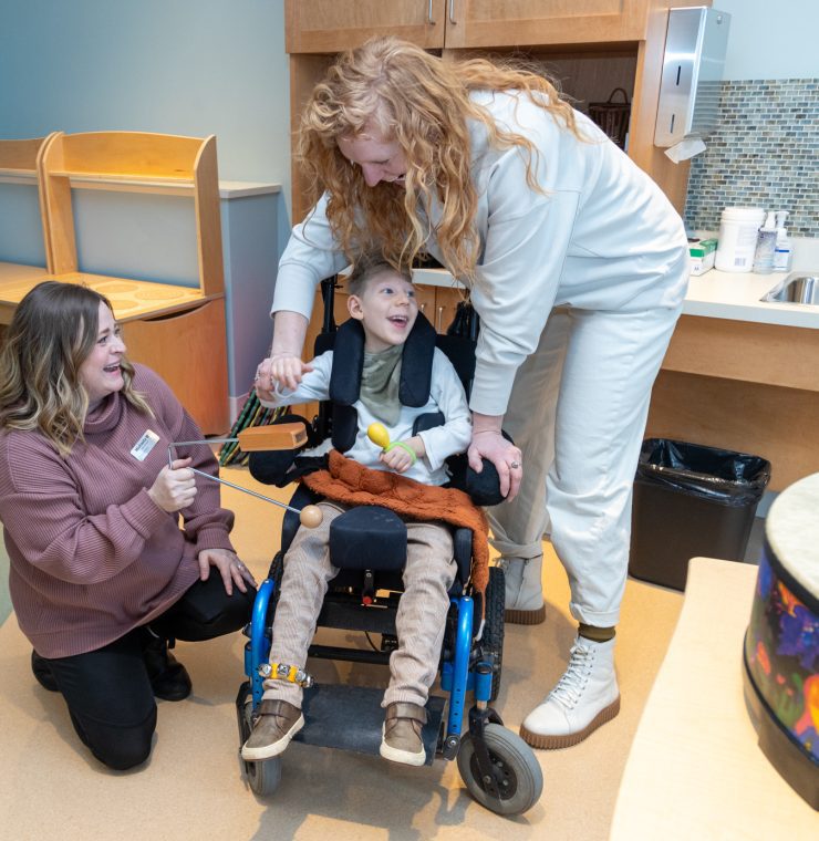 The Braun family enjoy a Music Therapy sessions with Canuck Place Music Therapist Michaela Wallis.