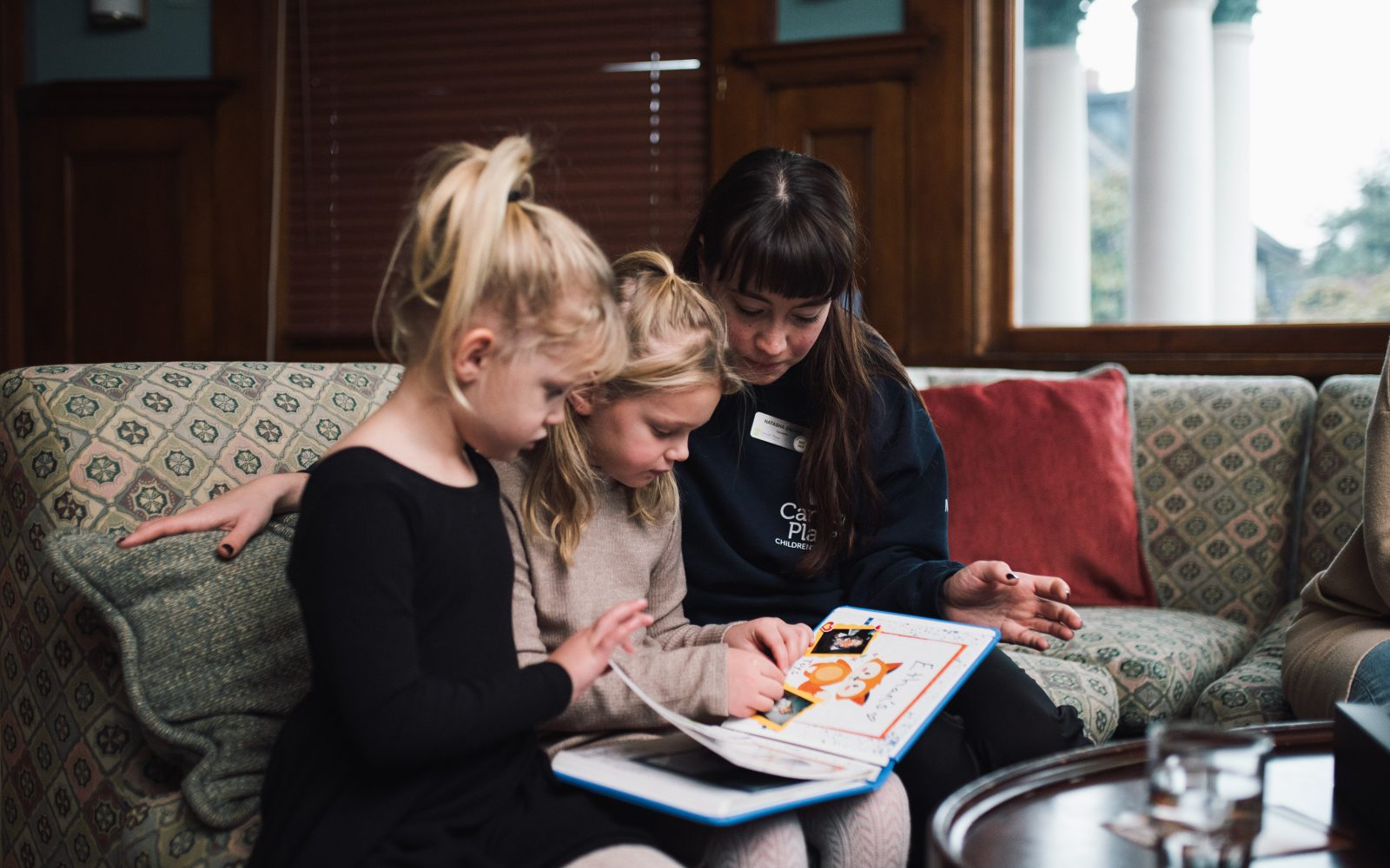 Brinley and Felicity Van Oosterom look at the Precious Pictures scrapbook that they made with their family in memory of their baby brother Ethan. 